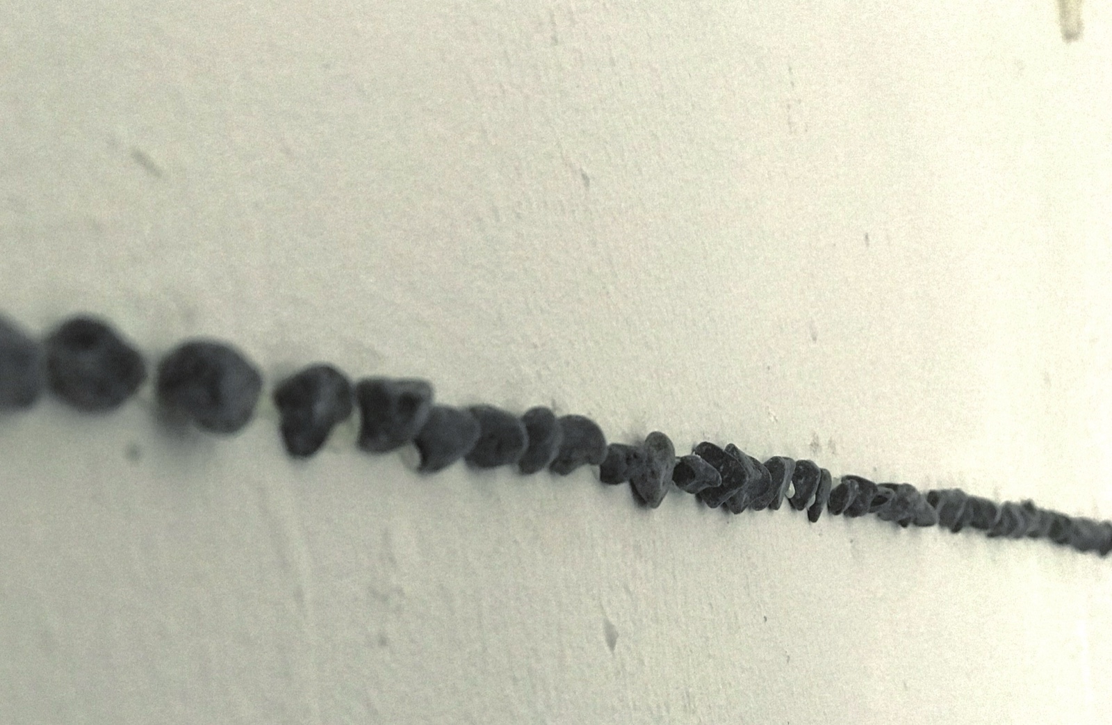 Individual and Sequence — close-up of stone line on wall
